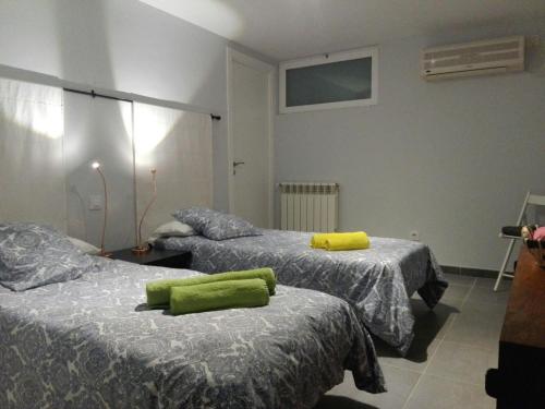 a room with two beds with green towels on them at COZY APARTAMENT 10 MINUTES FROM THE HEART OF MADRID in Madrid