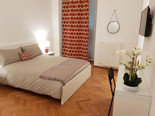 a bedroom with a bed and a table with a tv at BorgoAntico34 - Luxury Room in Molfetta