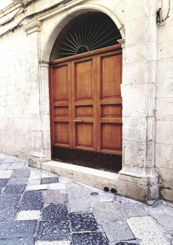 a wooden door on the side of a building at BorgoAntico34 - Luxury Room in Molfetta