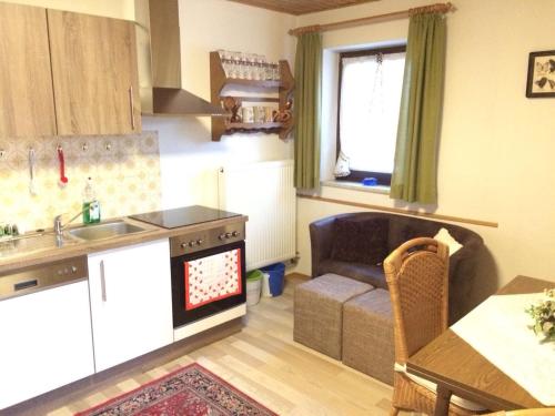 a kitchen and living room with a couch and a table at Haus Liesal in Spiegelau