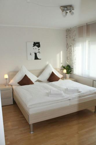 a bedroom with a large white bed in a room at Ferienhaus im Nürburgring in Herschbroich