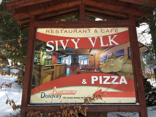 a sign for a restaurant and cafe sky viki and pizza at Apartment Dony in Donovaly
