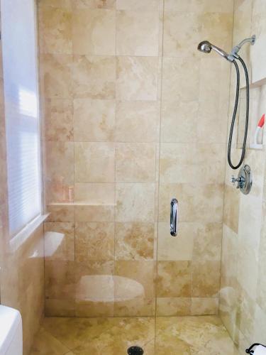 a shower with a glass door in a bathroom at Avalon Beach in Fort Pierce