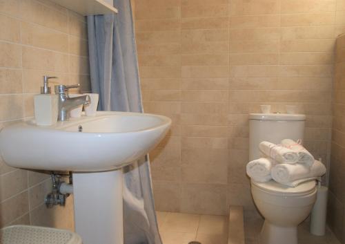 a bathroom with a sink and a toilet at Kiveri Gems Houses in Kivérion