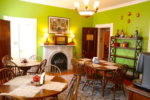a dining room with two tables and a fireplace at Stepping Stone Inn in Salem