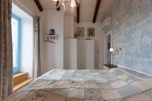 a bedroom with a large bed in a room at Krk Houses in Kornić