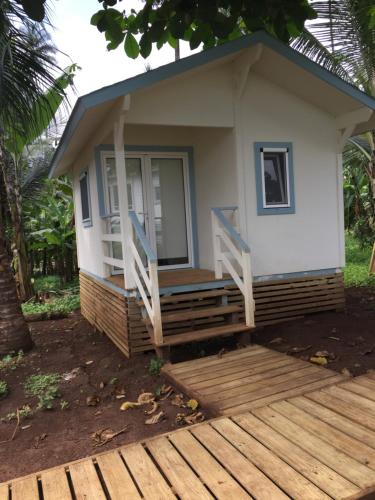 a small house with a porch and a deck at N`Guembú Nature Resort in Porto Alegre