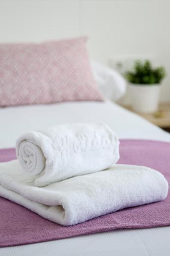 a pile of towels sitting on top of a bed at Aparthotel Cye Holiday Centre in Salou