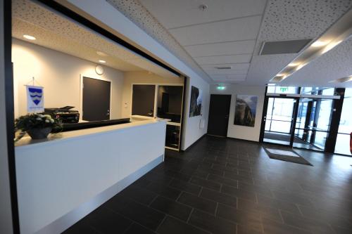 an office lobby with a counter in the middle of it at Tananger Apartment Hotel in Tananger