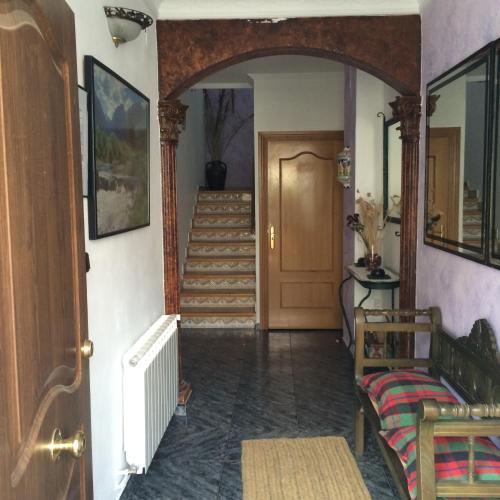 a hallway of a house with a door and stairs at Hostal Almenara in Paterna del Madera