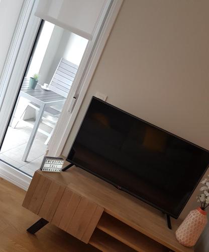 a large flat screen tv sitting in a living room at Smart Urban Orio in Orio