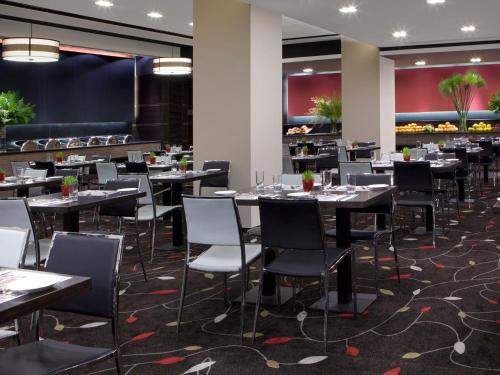 a dining room filled with tables and chairs at Dan Panorama Jerusalem Hotel in Jerusalem