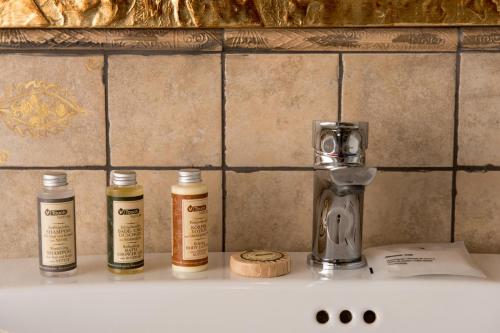 a counter with three bottles of essential oils on it at Luxury Relais Cuore Sabino in Stimigliano