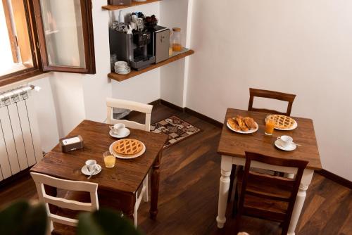 a dining room with a table and chairs with food on it at Luxury Relais Cuore Sabino in Stimigliano