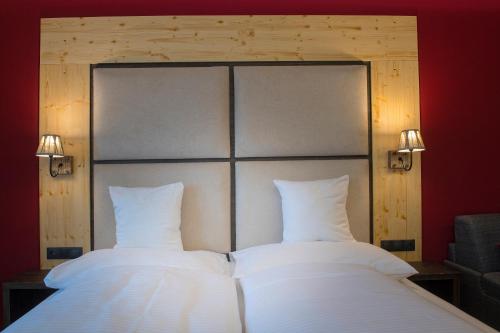 two beds with white sheets and two lights on them at Penzión Šafrán in Ždiar