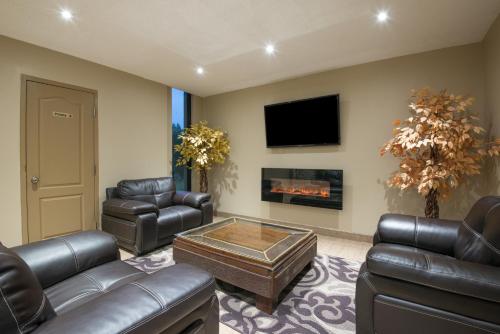 a living room filled with furniture and a fire place at red maple inn and suites in Huntsville