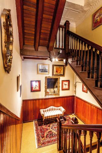 a living room with a staircase and a couch at Amsterdam Castle NY in Amsterdam