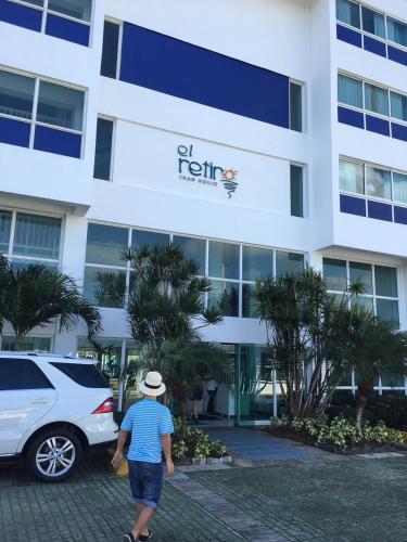 a man walking in front of a hotel at Apartamento Juan Dolio in Juan Dolio