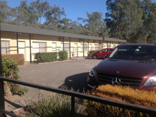a car parked in front of a building at Grampians Motel /Hotel in Dadswells Bridge