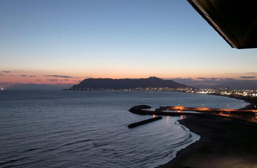a view of the ocean at sunset at Heiseikan Shiosaitei Hanatsuki in Hakodate