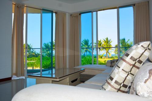 a bedroom with a view of the ocean at Pearl Of Ocean Front in Trincomalee