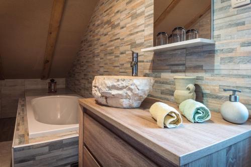 a bathroom with a sink and a bath tub at Apartments Fairy Land in Rakovica