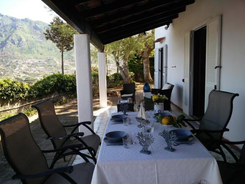 a table with a white table cloth on a patio at Villa Andrea in Ischia
