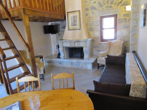 a living room with a couch and a fireplace at Kyrimi in Gerolimenas