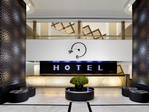 a lobby of a hotel with a sign that says hello at Dan Panorama Tel Aviv Hotel in Tel Aviv