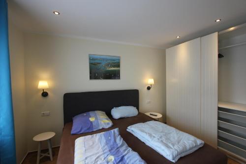 Postel nebo postele na pokoji v ubytování Ferienwohnung in Warnemünde, Friedrich-Franz-Straße 11