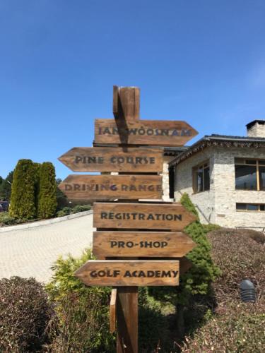 a directional sign in front of a building at Pirin Golf Villa Emila in Bansko