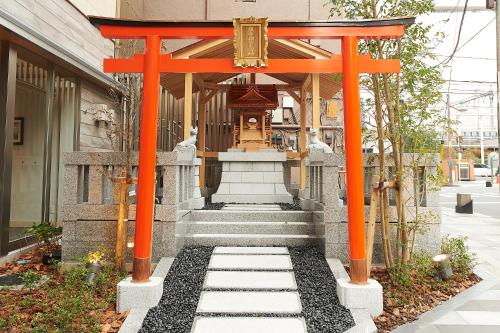 an orange torii gate in front of a building at Sotetsu Fresa Inn Tokyo Kinshicho in Tokyo