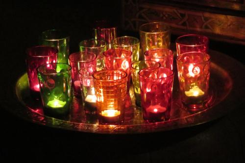 a group of glasses filled with lights on a tray at Riad Jnane d'Ô in Marrakech