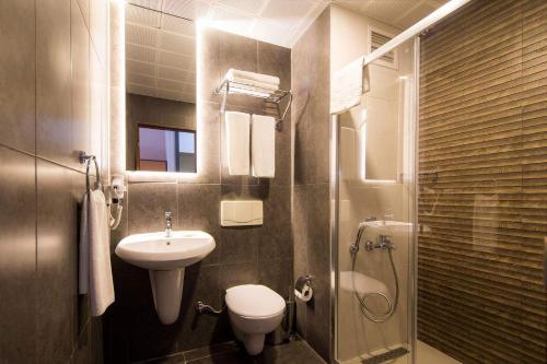 a bathroom with a sink and a toilet and a shower at Club Hotel Sunbel in Kemer