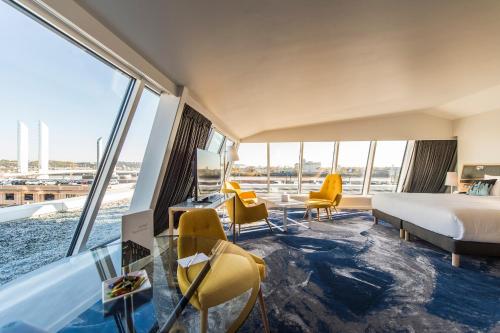 a hotel room with a bed and a view of the city at Seeko'o Hotel Bordeaux in Bordeaux