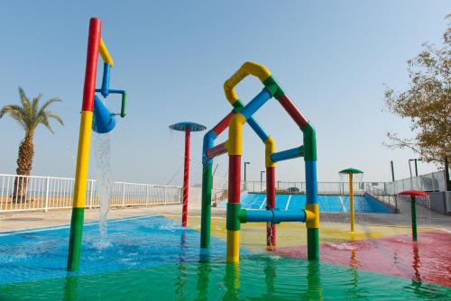 a water park with a water slide in a pool at Leonardo Club Hotel Dead Sea - All Inclusive in Ein Bokek