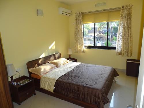 a bedroom with a bed with two pillows and a window at Casale Majorda in Majorda