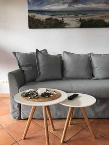 a living room with a couch and a table with a pizza on it at Haus Hugo in Zingst