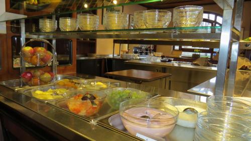 a kitchen with many bowls of fruit on a counter at Hotel Rebstock in Rust