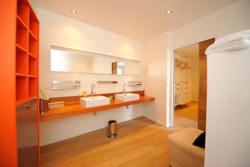 une salle de bain avec deux lavabos et un miroir dans l'établissement Suite Les Couchants, à Porticcio