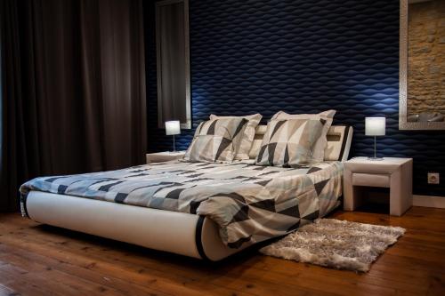 a bedroom with a bed with a blue headboard at Villa Des Ursulines in Bayeux