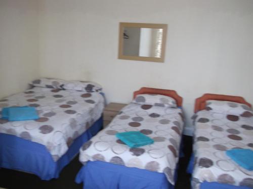 two beds sitting next to each other in a room at Durham house hotel in Gateshead