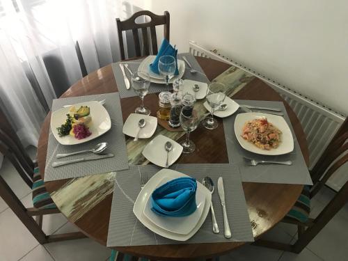 a wooden table with plates of food on it at Hotel Aysen Austral in Puerto Aisén