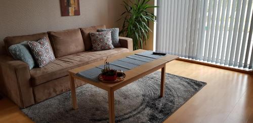 a living room with a couch and a coffee table at Toscana Restaurant and Bed & Breakfast in Padborg