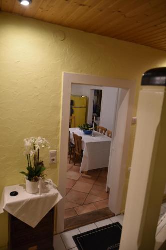 a dining room with a table and a mirror at Ferienwohnung Domäne Süpplingenburg in Süpplingenburg