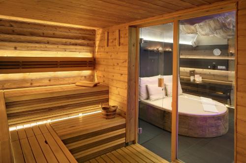 a sauna with a bed and a tub in it at Chateau St. Havel - Wellness Hotel in Prague