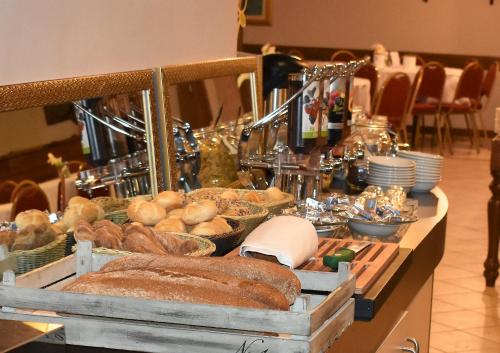 a buffet with bread and other food on a table at Hotel Country Club in Capannori