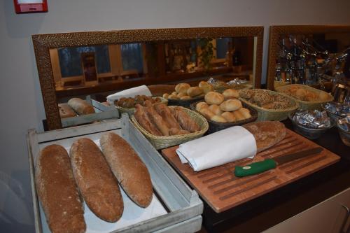a table with bread and other foods on at Hotel Country Club in Capannori