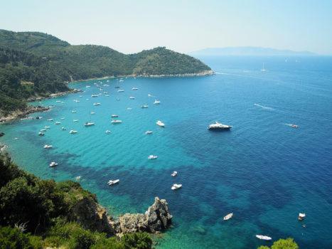 a group of boats in a large body of water at Hotel da Renato in Albinia
