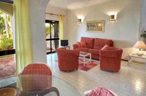 a living room with a couch and two chairs at T2 Holiday Cottage near the beach C225 in Porches